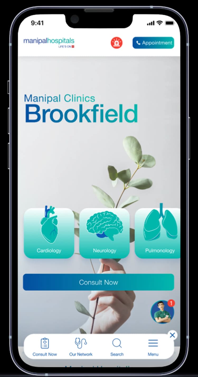 The Manipal Hospitals app open on a phone, showing Manipal Clinics Brookfield with Cardiology, Neurology and Pulmonology and a Consult Now button